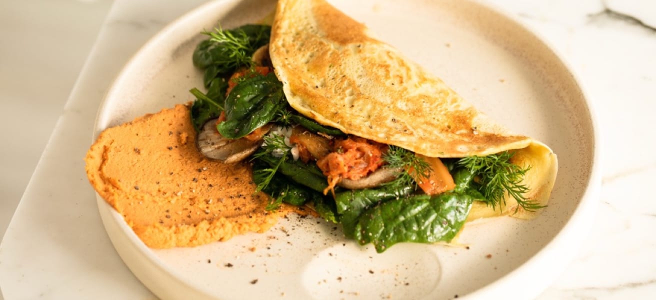 An omelette on a round ceramic dish